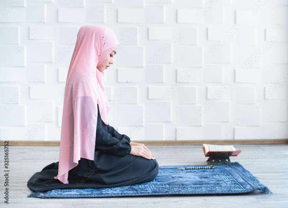 Pretty muslim girl praying