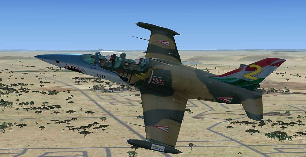 The Aero L-39 Albatros, ZU-MIG, is seen left side on as it banks over the town of Koster towards Morningside Farm to it’s south. The white helmets of Alex in the front cockpit and Ally in the rear cockpit flashes in the morning sun.