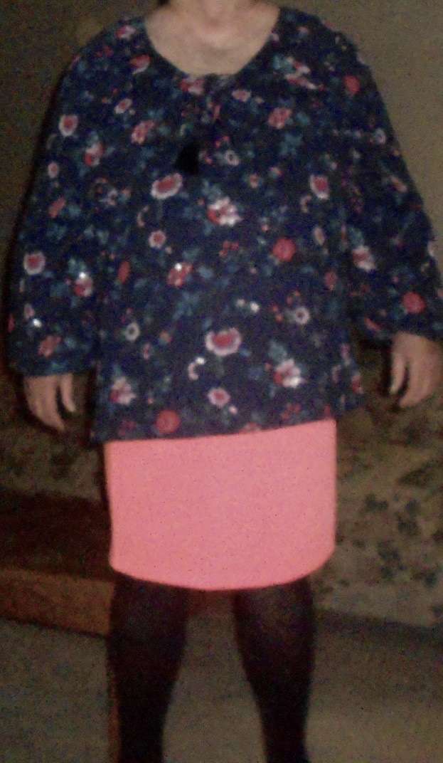 Person in black stockings, pink skirt and flowery top