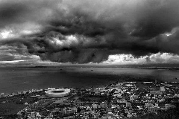 Arial picture of a large city with massive storm clouds over it