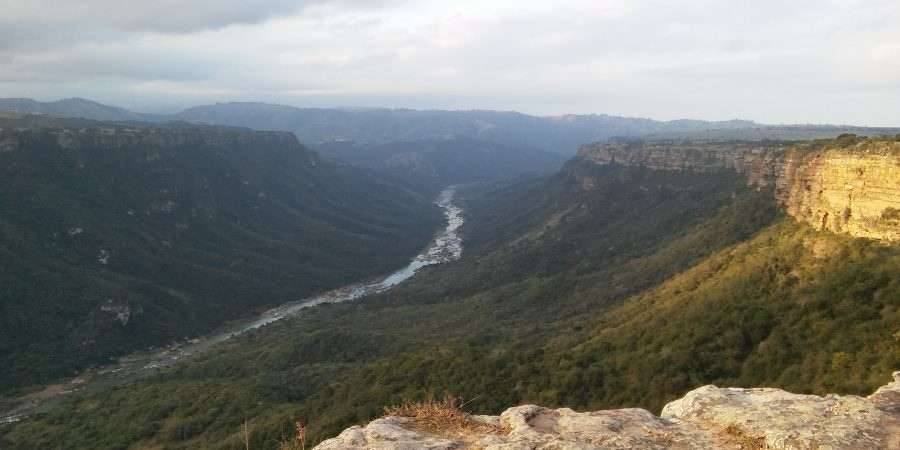 View of a forested valley with a river in its middle
