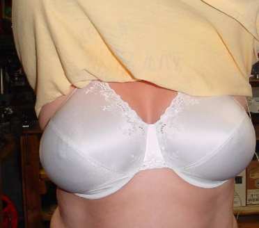 Woman taking shirt off, wearing white bra under