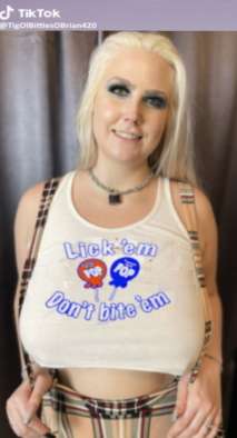 Blonde with big tits wearing t-shirt with message: lick’em, don’t bite’m