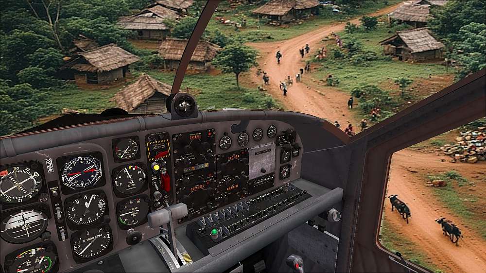 A view out of the cockpit of the PC-6 Porter as Dolf and Nisreen overfly the village and inspecting the dirt road that will serve as a runway. People, goats, and an ox wagon is seen on the road from the perspective of Nisreen in the right seat.
