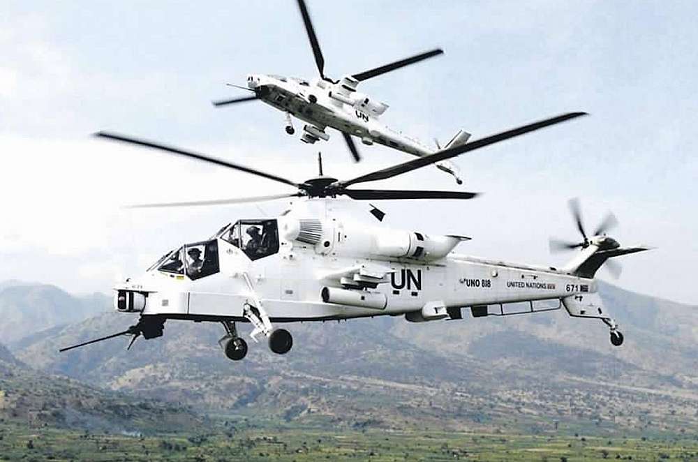 The picture display two Denel Aviation Rooivalk attack helicopters of the South African Air Force, but painted in UN peacekeeping force colours, flying over the Congo landscape.