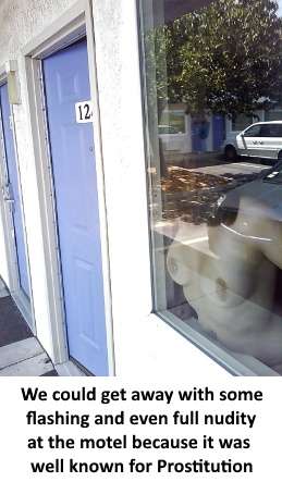 Topless woman pressing her naked breasts to a window