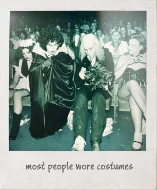 People wearing costumes in a theatre