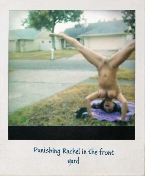 Naked girl standing on her head outdoors, with her legs spread in a Y