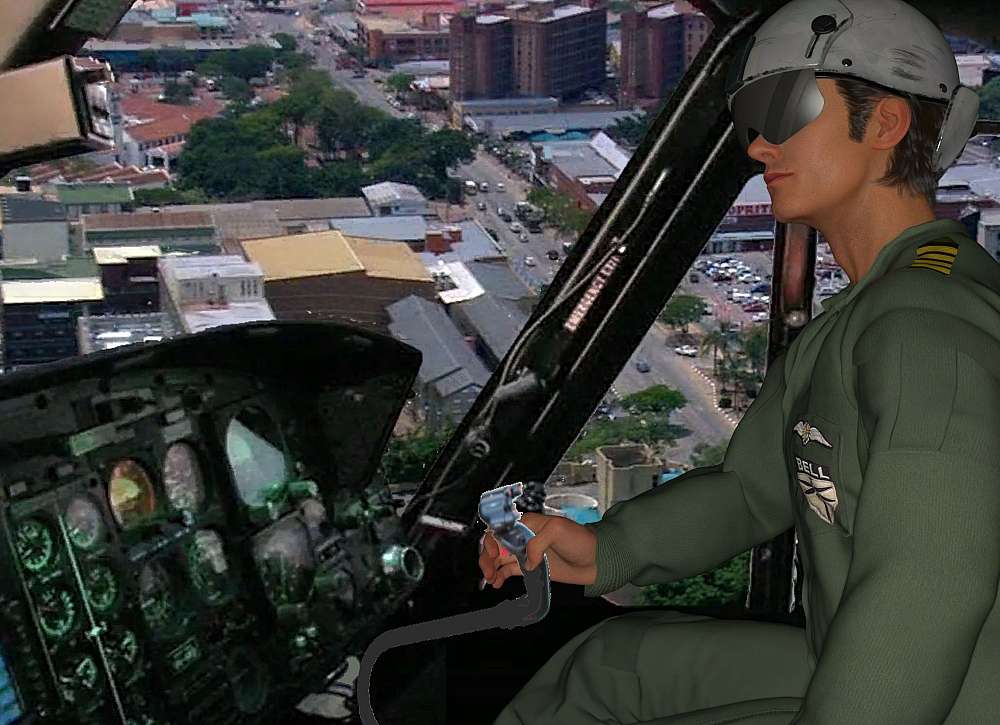 Adrian in the cockpit of the Bell 222 as he flies over the city of Mbombela / Nelspruit. The picture show a side view of Adrian and the cockpit, with the city seen in the background out of part of the windscreen and side windows of the helicopter.