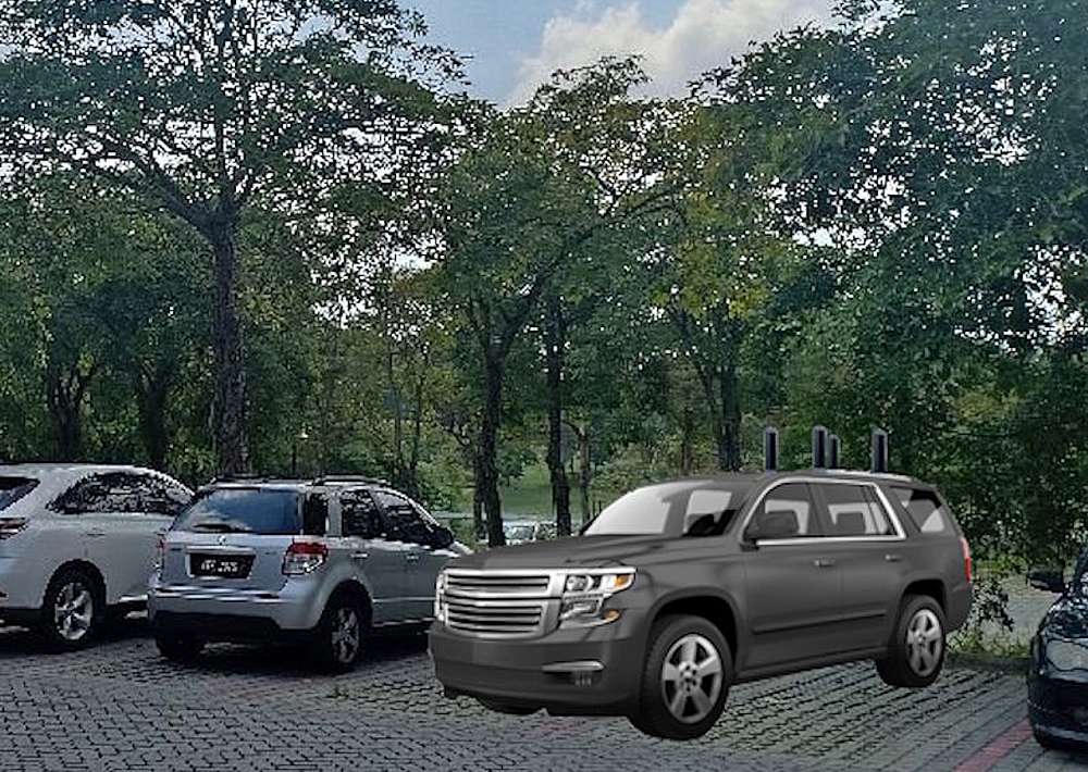 In the picture a black SUV sits in the parking lot outside the Lakeside suites. Mounted on the roof was the funny 4-way layout of a tracking antenna array.