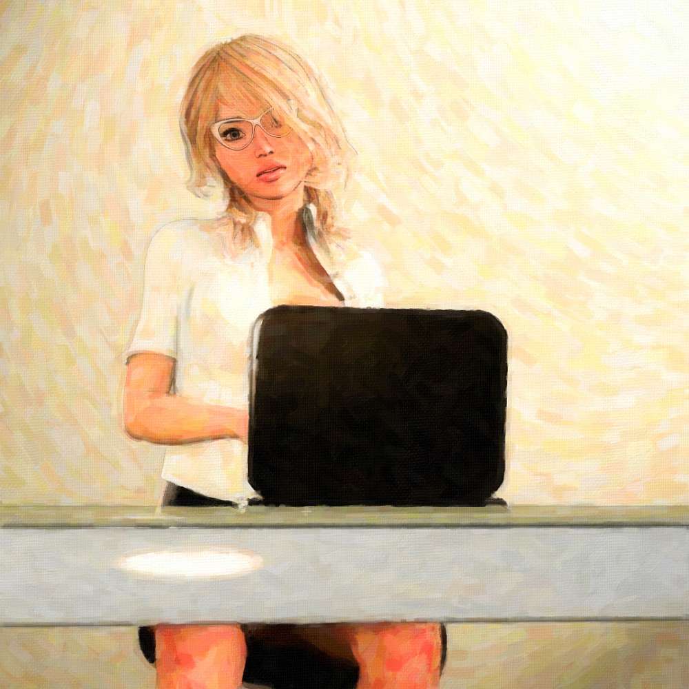 blond girl sitting in front of laptop