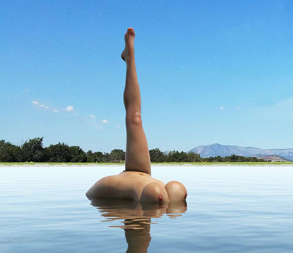 Floating naked woman sticking her leg straight up from the water